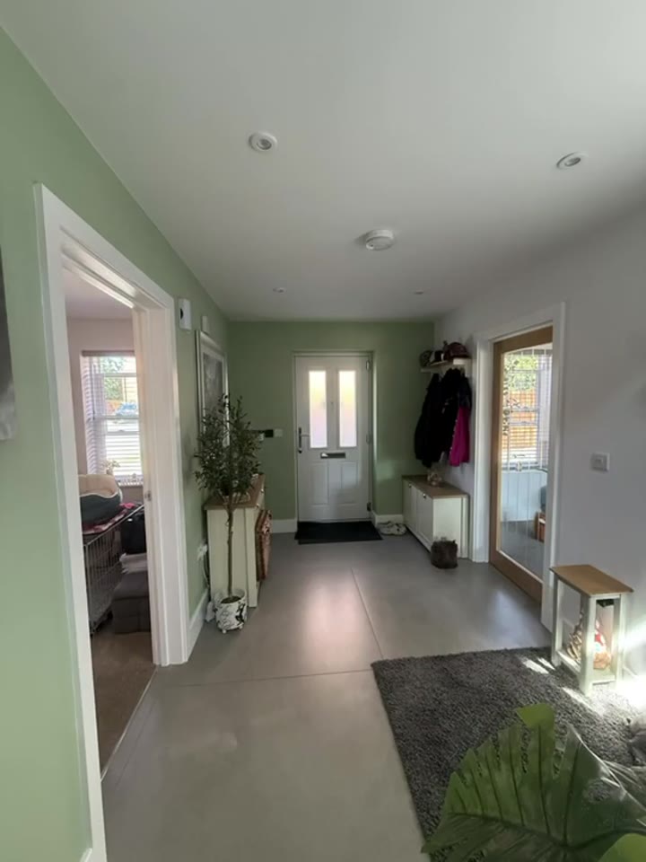 Finished AA-painted hallway with a sage-green feature wall