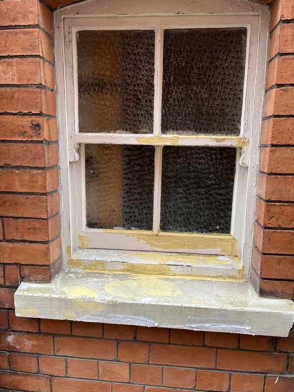 Before: Masonry window before and after restoration
