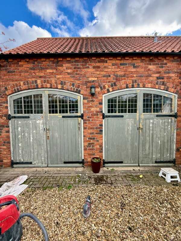 Before: Barn doors before and after repainting