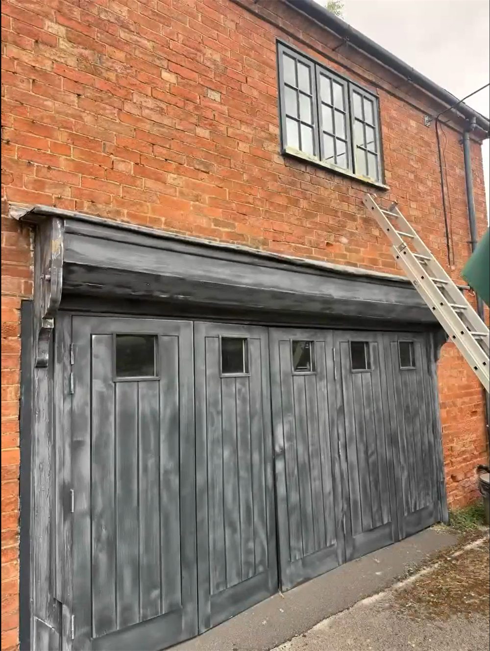 Before: Barn folding doors before and after repainting